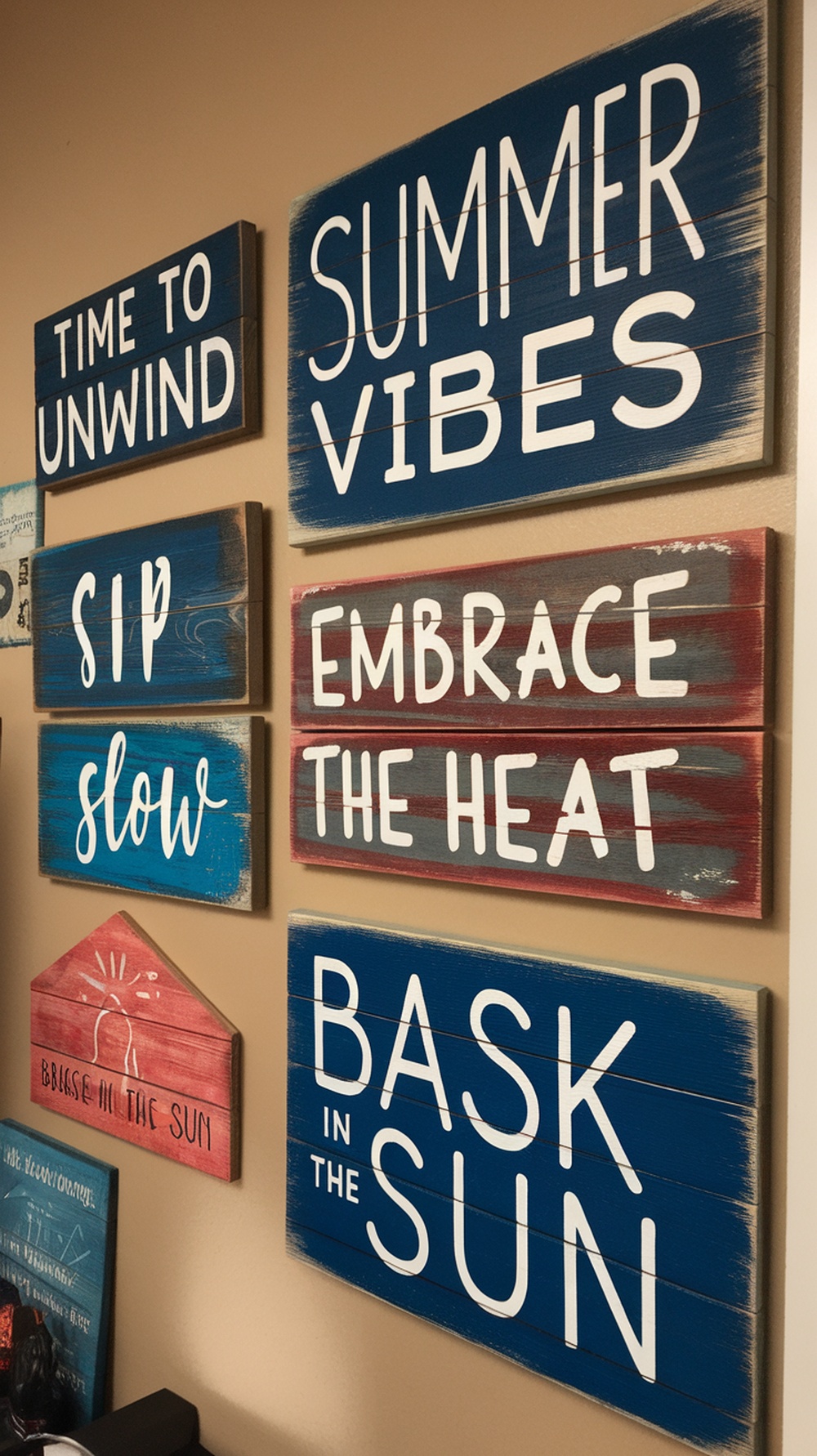 Painted wooden signs with summer themes in a home office setting.