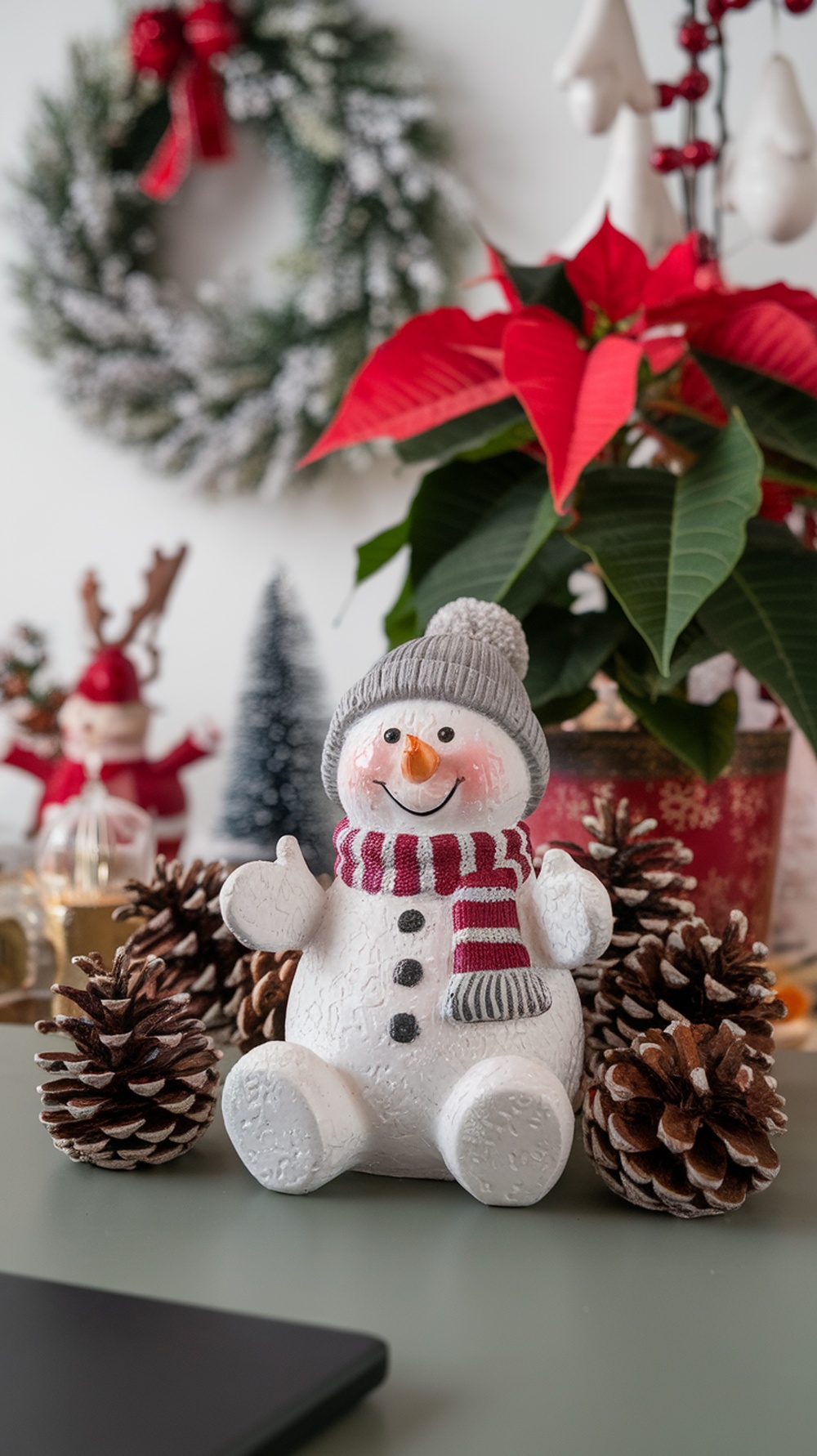A cheerful snowman figurine with a scarf, surrounded by pinecones and winter decorations.